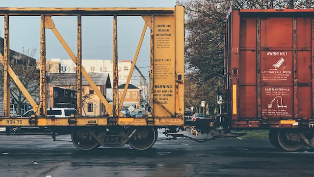 train cars with buildings visible behind them